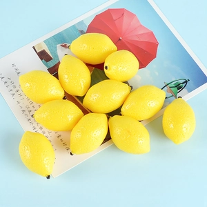 Vibrant yellow artificial mini lemons on a postcard for home decor and photography