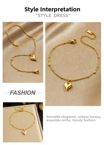 Detailed view of a gold-plated stainless steel heart pendant bracelet on champagne silk