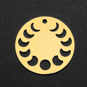 Macro detail of a golden moon phase celestial pendant on a black textured background