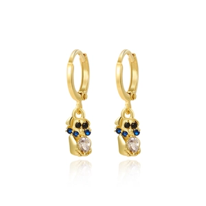 Detail view of gold hoop earrings with cute cartoon animal charms and sparkling gemstones