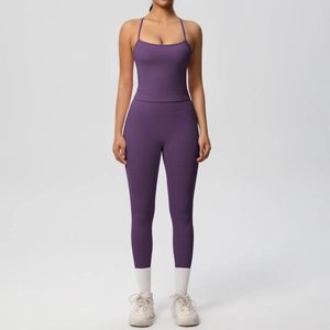 Detail of purple high-waist yoga set featuring a strappy sports bra and seamless leggings