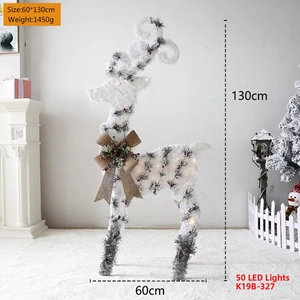 Close-up of lighted flocked reindeer with pine cones and berries for Christmas decor