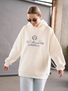 Detail of The Movement Club navy lettering on cream oversized thick hoodie front