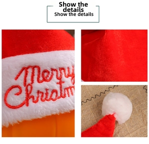 Detail of red plush Christmas hat showing Merry Christmas embroidery and fuzzy texture
