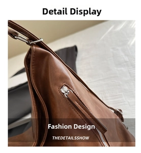 Close-up of silver metal zipper and textured brown leather on a vintage tote bag