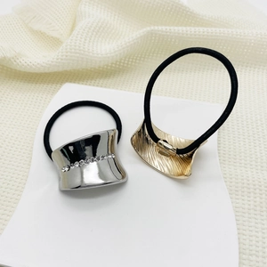 Detail of eco-friendly alloy hair ties with gold brushed and silver rhinestone accents