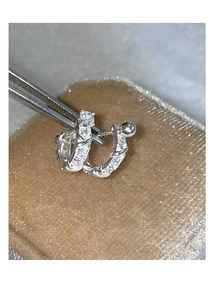 Macro shot of S925 silver U-shaped hoop earrings with zircon stones and metal ball backings