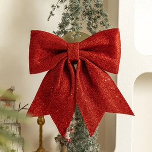 Large red Christmas bow with glitter finish for tree ornaments and festive window display