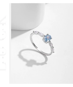 Detail view of oval light blue crystal and S925 sterling silver stamp on the ring band