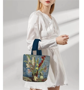 Detail view of Van Gogh style floral oil painting handbag with dark blue top handles