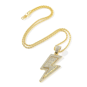 Close-up of golden lightning bolt pendant with sparkling crystals and twisted rope chain
