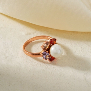 Elegant rose gold flower ring with center pearl and colorful zircon stones on cream fabric