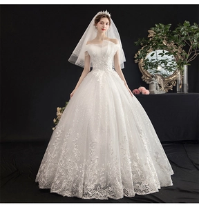 Detailed embroidery and sequins on off-shoulder bridal gown with lace edging