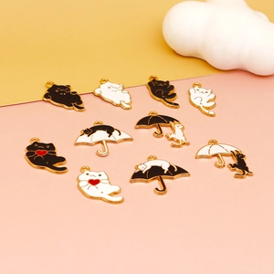 Detailed set of ten Halloween black and white cat alloy enamel charms in cute poses