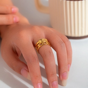 Detail of gold double-layer titanium ring featuring smooth flat plate and Cuban chain links