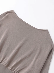 Detail of soft knit fabric texture and elegant boat neck collar on taupe sweater