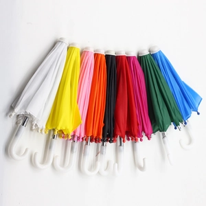 Detailed view of colorful 18-inch doll umbrellas hanging on a white wall in a fan-shaped layout