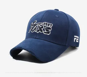 Close-up of distressed brim detail and white embroidery on dark blue baseball cap