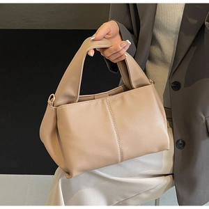 Close-up of beige PU leather shoulder bag showing detailed stitching and premium texture