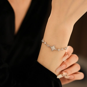 Gros plan détaillé d'un bracelet étoile à quatre branches en argent avec oxydes de zirconium