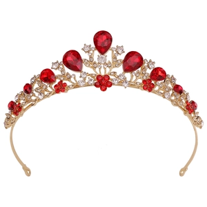 Detailed macro of golden bridal crown featuring red teardrop gemstones and crystals
