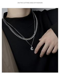 Fashionable double-layer silver Cuban chain necklace with crescent pendant on a model