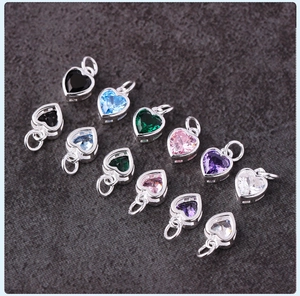 Detailed macro view of colorful heart-shaped cubic zirconia charms for jewelry making