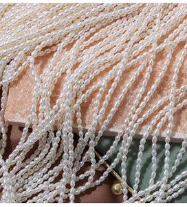 Macro detail of 4mm creamy white rice-shaped freshwater pearls with strong luster texture