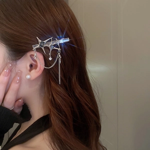 Detail view of silver Y2K star hair clip with rhinestones and fringe tassels on hair