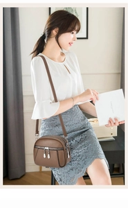 Brown PU leather crossbody bag with multiple silver zipper pockets and layered storage