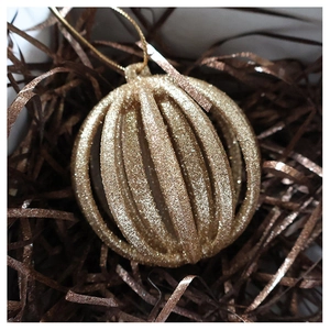 Detail of champagne gold hollow striped lantern Christmas ball with glitter texture