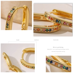 Macro detail of gold U-shaped hoop earrings with colorful inlaid zircon and mirror polishing