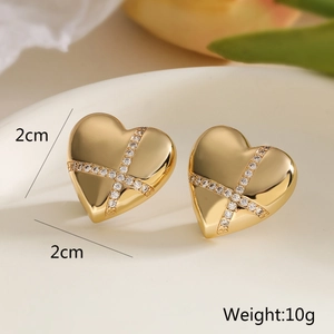 Detail showing 2cm gold heart earrings with cross design, cubic zirconia, and 10g weight