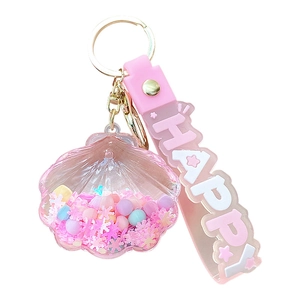 Pink shell liquid quicksand keychain with golden metal ring and happy wrist strap