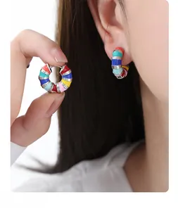 Detail of colorful enamel hoop earrings with vibrant macaron colors and silver metal lines