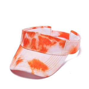 Detail of orange and white tie-dye sun visor with adjustable velcro strap closure