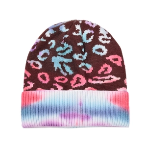 Detail of leopard print beanie showing tie-dye knit cuff and colorful jacquard pattern