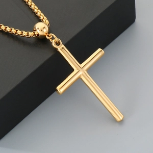 Polished gold stainless steel cross necklace with sleek box chain and spherical bead accent