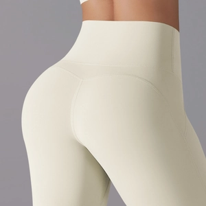 Detail showing high-waisted cream yoga leggings with V-shaped stitching for a lifting effect