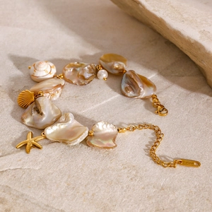 Detailed shot of ocean shell bracelet with starfish charms and mother of pearl beads