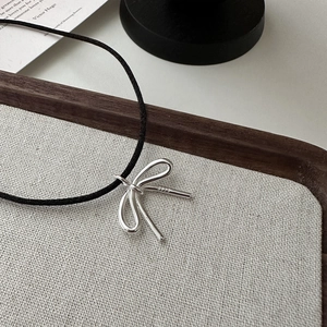 Elegant s925 sterling silver bow pendant on black cord necklace with minimalist styling