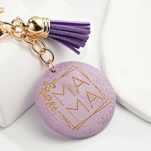Detail of purple wooden MAMA keychain with leopard print and matching suede tassel