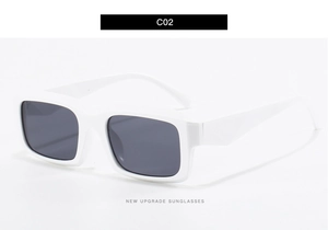 Detail view of square white gradient sunglasses with dark grey lenses in a side profile