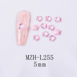 Detailed view of 5mm aurora pink star-shaped nail gems on glittery manicure
