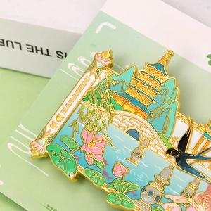 Close-up of Hangzhou West Lake metal enamel fridge magnet with lotus and pagoda design
