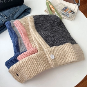 Top view of colorful ribbed knit balaclavas with buttons in blue, pink, beige and grey