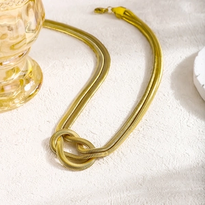 Minimalist double-layer golden snake chain necklace with a stylish knotted metal design