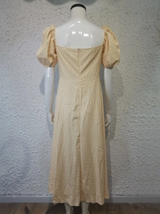 Rear view of yellow puff sleeve floral maxi dress on mannequin with back zipper detail