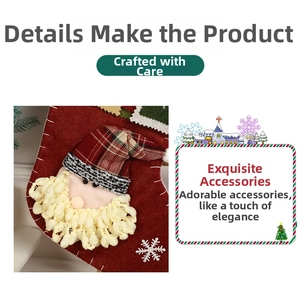 Detail of red velvet Christmas stocking with stitched Santa Claus and white snowflake motifs