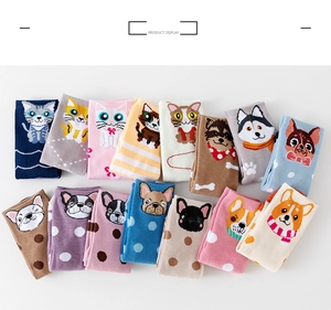 Flat lay detail of cute cartoon animal patterned socks in various vibrant colors and styles